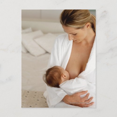 Close up view of a mother breastfeeding her baby postcard