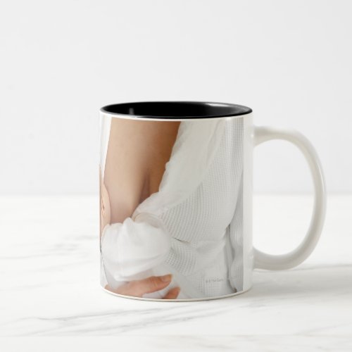 Close up view of a mother breastfeeding her baby Two_Tone coffee mug