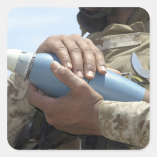 Close-up view of a soldier cradling a munition square sticker