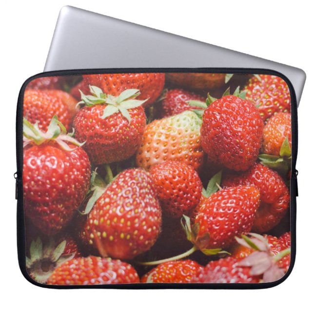 Close-up view on fresh summer strawberry with vint laptop sleeve (Front)