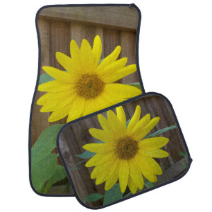 Close up yellow sunflower on a car floor mat
