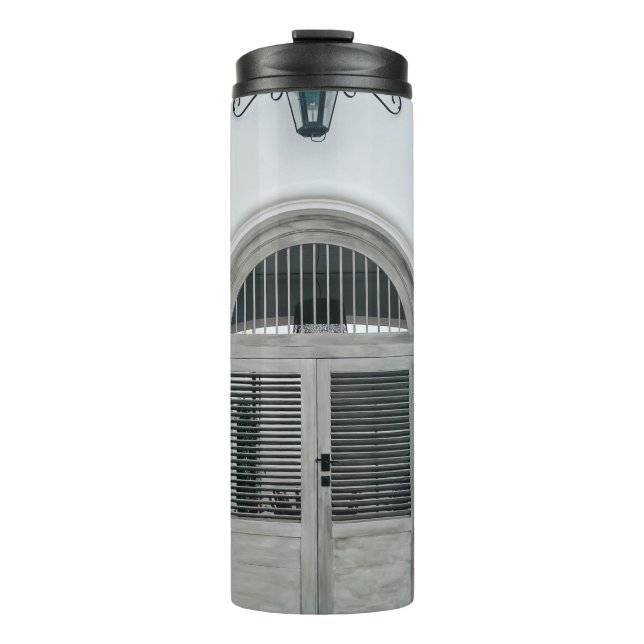 CLOSED GREY WOODEN DOOR BELOW BLACK LIGHT SCONCE THERMAL TUMBLER (Front)