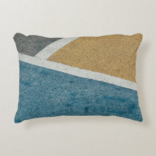 Closeup gray, yellow, and blue painted pavement accent pillow
