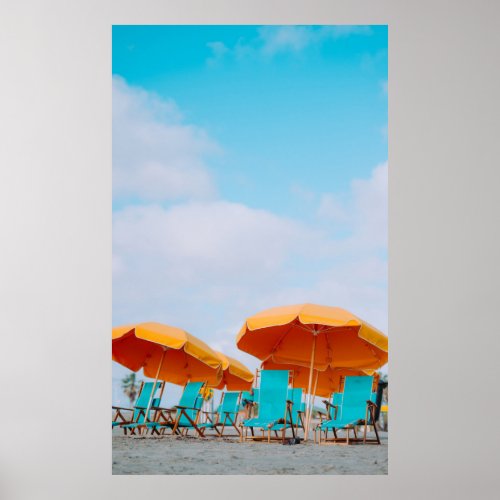 Closeup photo of lounger chairs and beach umbrella poster