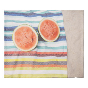 Closeup photo of slice watermelon fruits on cloth duvet cover
