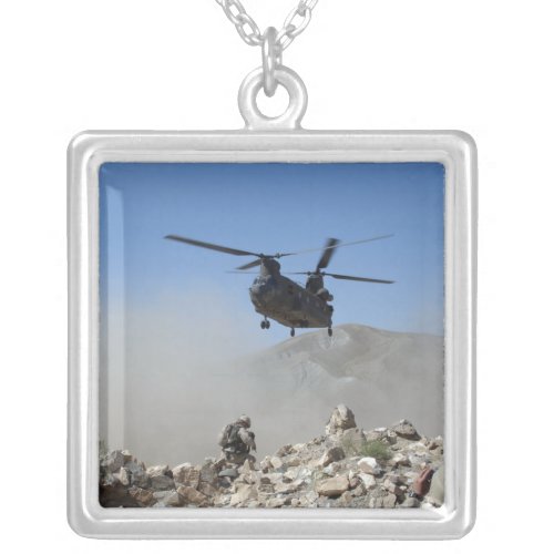 Clouds of dust kicked up by the rotor wash silver plated necklace
