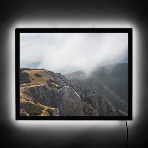 Clouds rolling over mountains LED sign