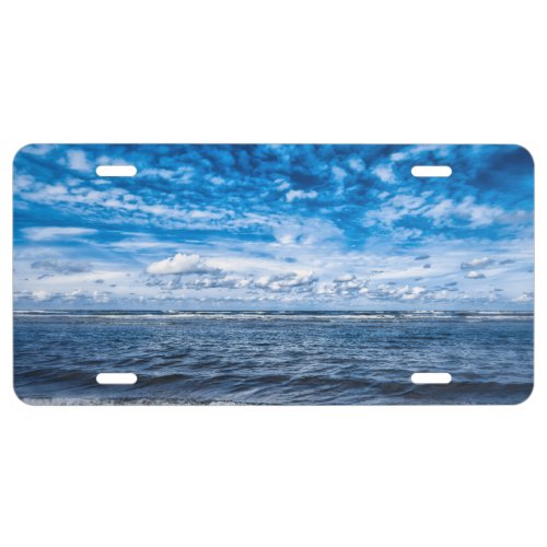 Cloudy day on the beach license plate