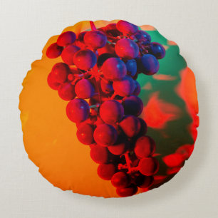 Cluster of blue grape in orange neon light. Food b Round Pillow