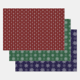 Cluster of Snowflakes on Deep Red, Green and Blue Wrapping Paper Sheets