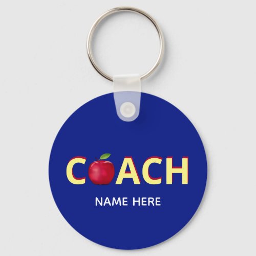Coach text with red apple on blue keychain