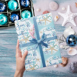 Coastal Beach Christmas SEAS & GREETINGS Wrapping Paper<br><div class="desc">Wrap your Christmas holiday gifts in coastal or beach flair using this roll of wrapping paper featuring a SEAS & GREETINGS elegant calligraphy script typography design accented with starfish in turquoise aqua blue on your choice of background color (shown with a light blue color). ASSISTANCE: For help with design modification...</div>