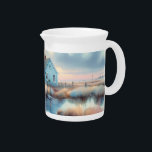 Coastal Cottage at Sunrise Marsh Beverage Pitcher<br><div class="desc">This peaceful illustration captures a charming blue coastal cottage nestled beside a calm marsh, bathed in the soft light of sunrise. The artwork evokes a sense of stillness and solitude, with gently swaying reeds, a weathered dock, and mirrored reflections in quiet waters. Warm pastel tones blend seamlessly with cool blues,...</div>