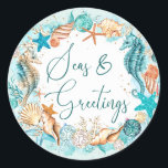 Coastal SEAS & GREETINGS Seahorse Shells Classic Round Sticker<br><div class="desc">Coastal, beach or tropical Christmas holiday season stickers featuring watercolor seahorses, starfish, shells and ornaments accented with faux glitter icons and the greeting SEAS & GREETINGS in modern handwritten script typography in turquoise, teal, golden brown and white on your choice of background color (shown in light turquoise). ASSISTANCE: For help...</div>