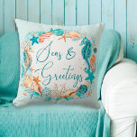 Coastal SEAS & GREETINGS Seahorse Shells Throw Pillow<br><div class="desc">Coastal or beach themed Christmas holiday season throw pillow featuring watercolor seahorses, starfish, shells and ornaments accented with faux glitter icons and the greeting SEAS & GREETINGS in modern handwritten script typography in turquoise, teal, golden brown and white on your choice of background color (shown in light turquoise). OPTIONS: The...</div>
