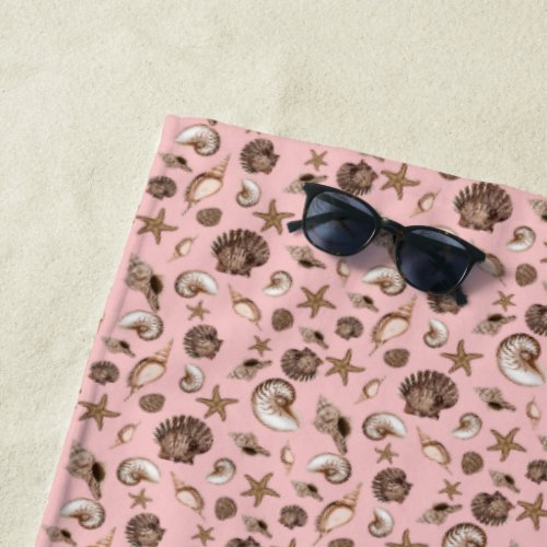 Coastal seashells on pink  beach towel