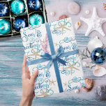 Coastal Tropical Christmas SEAsons Greetings Wrapping Paper<br><div class="desc">Wrap your Christmas holiday gifts in a tropical, coastal flair featuring SEAS & GREETINGS in an elegant calligraphy script typography design accented with starfish in turquoise aqua blue colors on an editable white background. ASSISTANCE: Contact the designer via Zazzle Chat or makeitaboutyoustore@gmail.com if you'd like this design modified or on...</div>