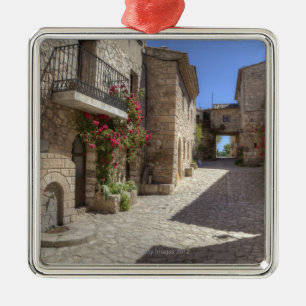 Cobblestone street, stone buildings, historic metal ornament
