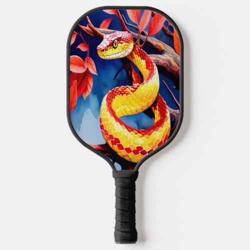 Cobra with vibrant red and yellow scales in tree pickleball paddle