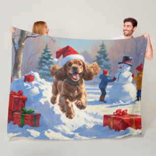 Cocker Spaniel Running in Snow with Christmas Hat Fleece Blanket