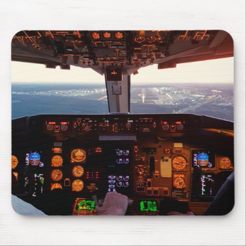 Cockpit view of commercial jet airplane landing on mouse pad