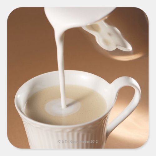 Coffee with milk being poured in square sticker