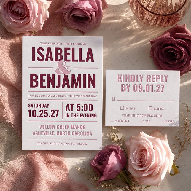 A collection of letterpressed wedding stationery with a burgundy color scheme. Purple and pink flowers are scattered around the RSVP and invite.