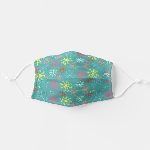 color snowflakes on teal green adult cloth face mask