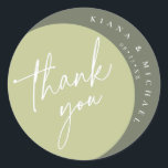 Color Tones Wedding Thank You Green ID901  Classic Round Sticker<br><div class="desc">With a color palette from ivory to spring green and dark moss, this wedding collection features a handwritten script font and eucalyptus leaf accents to add that wonderful modern touch. The 'Thank You' sticker shown here has all the above with a striking arced pattern in shades of green topped by...</div>
