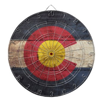 Colorado State Flag On Old Wood Grain Dartboard With Darts by electrosky at Zazzle