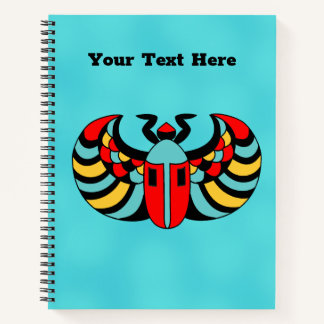 Colorful Bright Egyptian Scarab Beetle on Aqua Notebook
