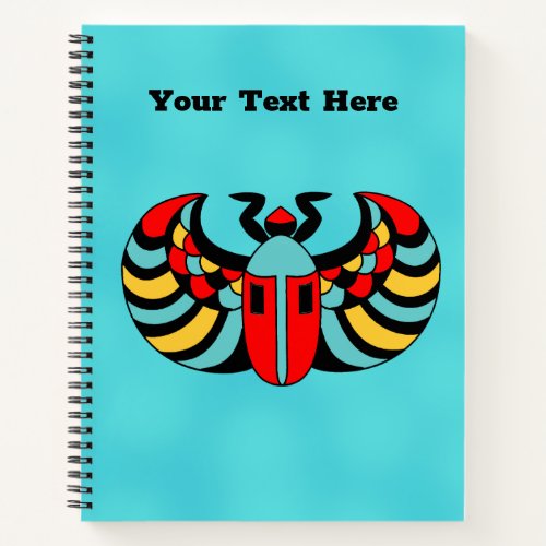 Colorful Bright Egyptian Scarab Beetle on Aqua Notebook