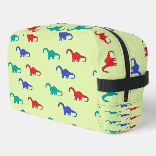Colorful dinosaurs pattern on green dopp kit