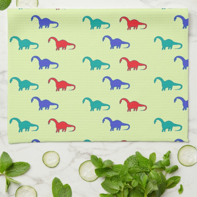 Colorful dinosaurs pattern on green kitchen towel (Folded)
