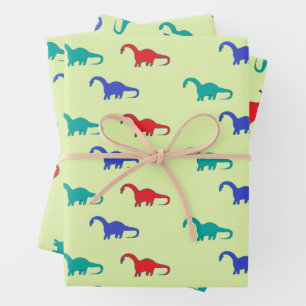Colorful dinosaurs pattern on green wrapping paper sheets