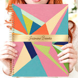 Colorful Geometric Abstract Custom Name Planner<br><div class="desc">This bold design showcases a vibrant geometric abstract pattern with vivid pink, blue, green, and orange tones. The central gold band elegantly highlights a custom name, creating a stylish and personal touch. Perfect for staying organized in school, work, or everyday life, this trendy design combines artistic flair with practicality. Whether...</div>