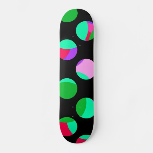 Colorful green purple circles on black skateboard