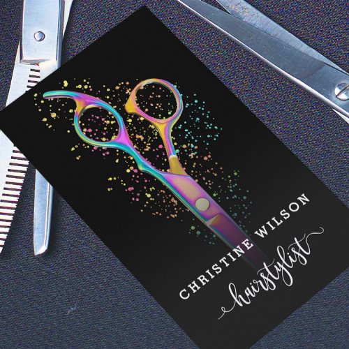 colorful hairdresser scissors on black business card