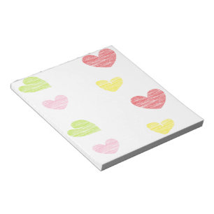 Colorful hearts on white notepad