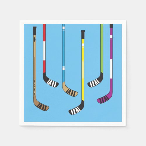 Colorful Hockey Sticks and Puck on blue Napkins