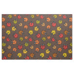 Colorful ladybugs on brown fabric