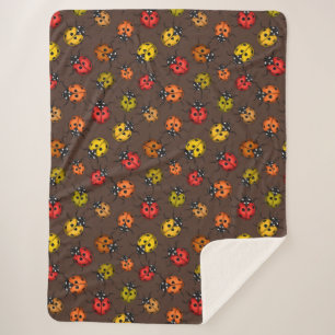 Colorful ladybugs on brown sherpa blanket