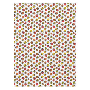 Colorful ladybugs on white tablecloth