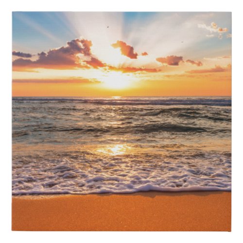 Colorful ocean beach sunrise with deep blue sky an faux canvas print