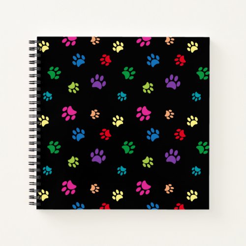 Colorful Painted Paw Prints on Black Notebook