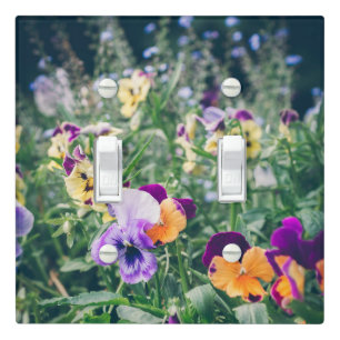 Colorful pansies in a summer country garden light switch cover