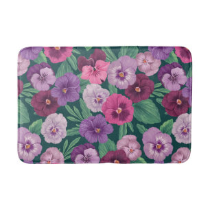 Colorful pansies on dark greenish blue bath mat