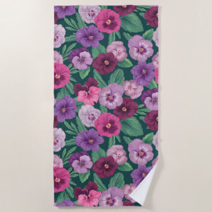 Colorful pansies on dark greenish blue beach towel