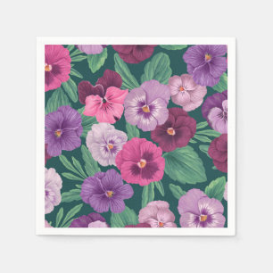 Colorful pansies on dark greenish blue napkins