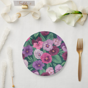 Colorful pansies on dark greenish blue paper plates